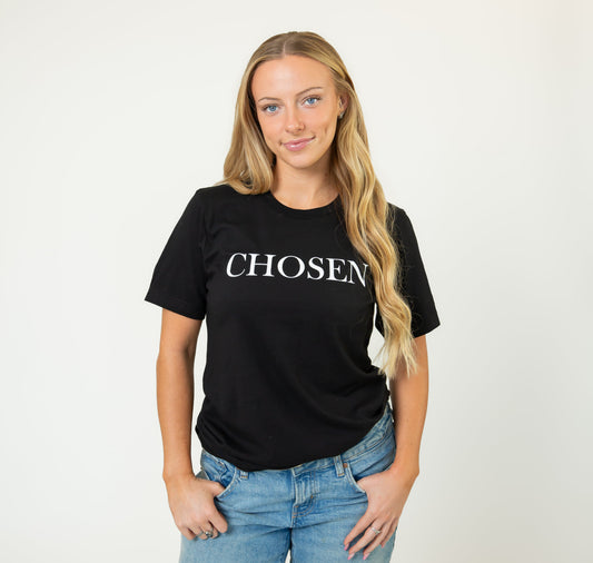 Woman wearing a black t-shirt with 'Chosen' text on a white background